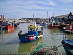 A fishing boat pulling into Whitstable's working harbour