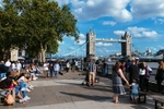 Tourists on a warm summer day with the London Tower Bridge in the background