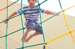 A boy mid-air jumping on a trampoline