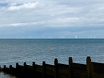 Groynes on Whitstable's beaches, with the Kentish Flats windfarm in the distance