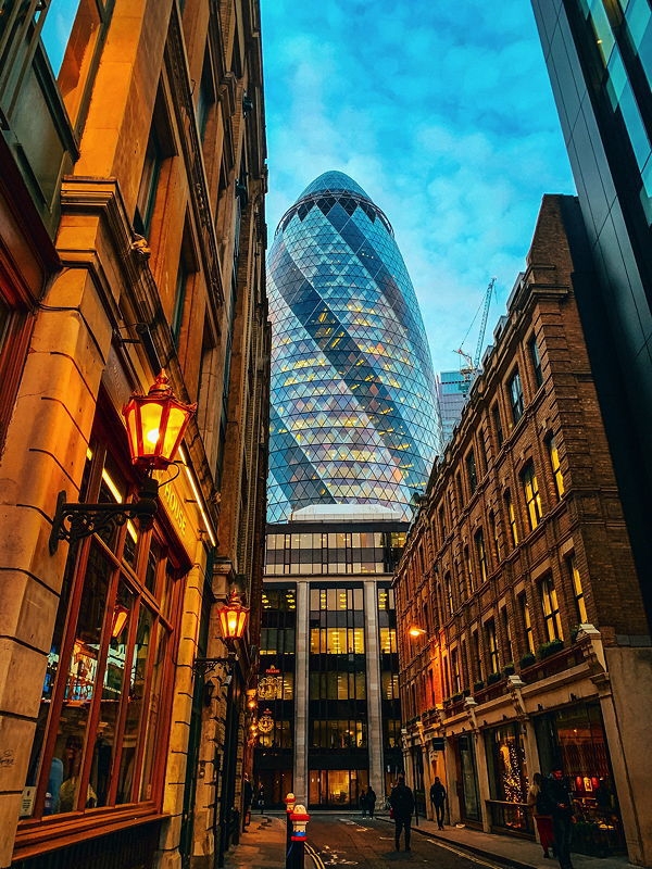 City of London, St Mary Axe (The Gherkin). Shot in the evening near dusk, the light gives an awesome effect on the Gherkin. The contrast of old and new is common in London.